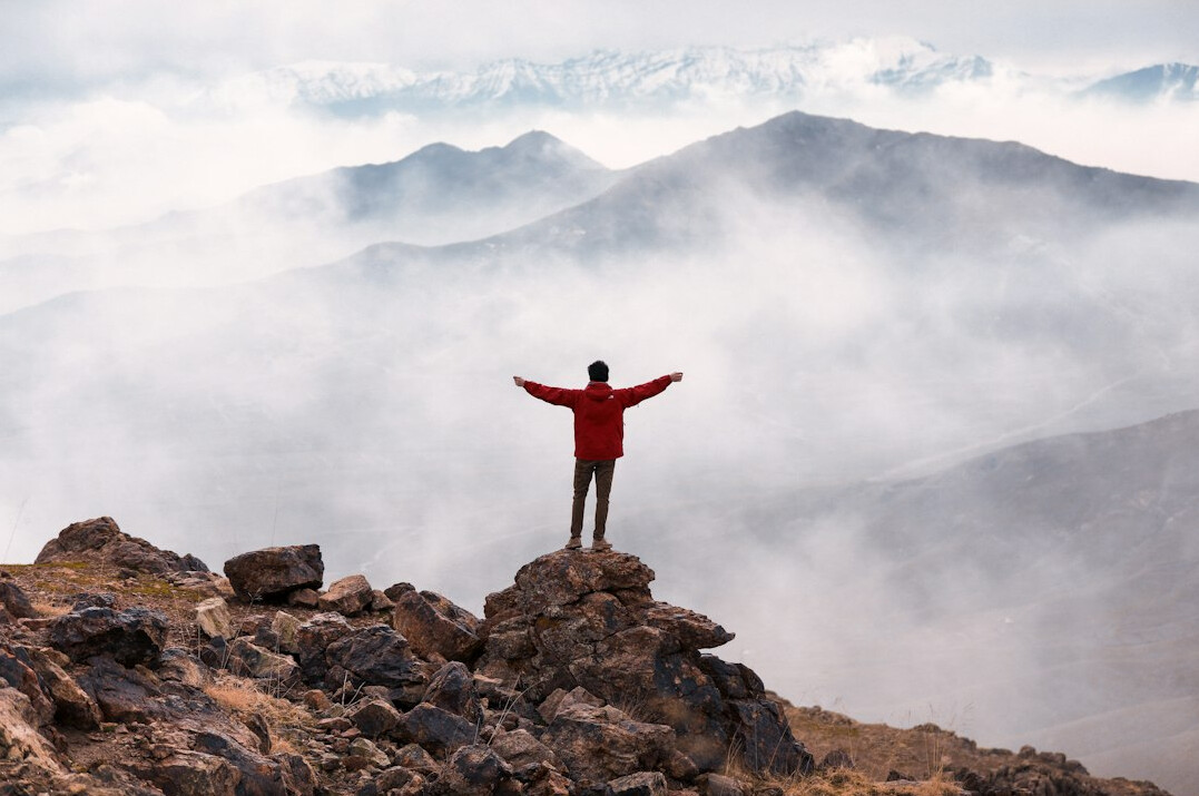 person achieving goals outdoors